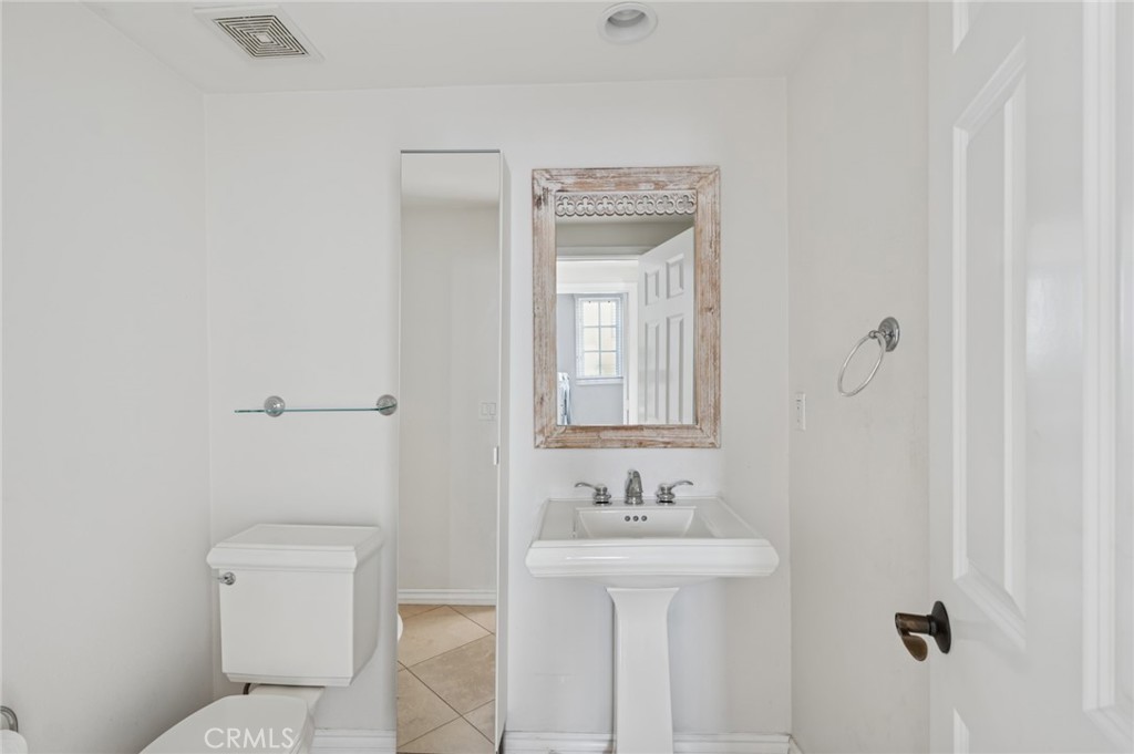 4 Still Water Newport Coast, CA 92657 - Photo 42 of 43 a bathroom with a sink a toilet and a mirror