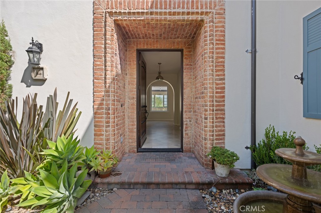 4 Still Water Newport Coast, CA 92657 - Photo 5 of 43 a front view of a house with potted plants