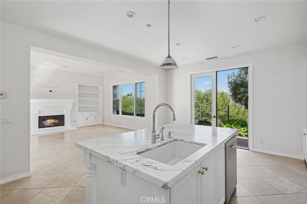 4 Still Water Newport Coast, CA 92657 - Photo 9 of 43 a kitchen with granite countertop a sink and white cabinets