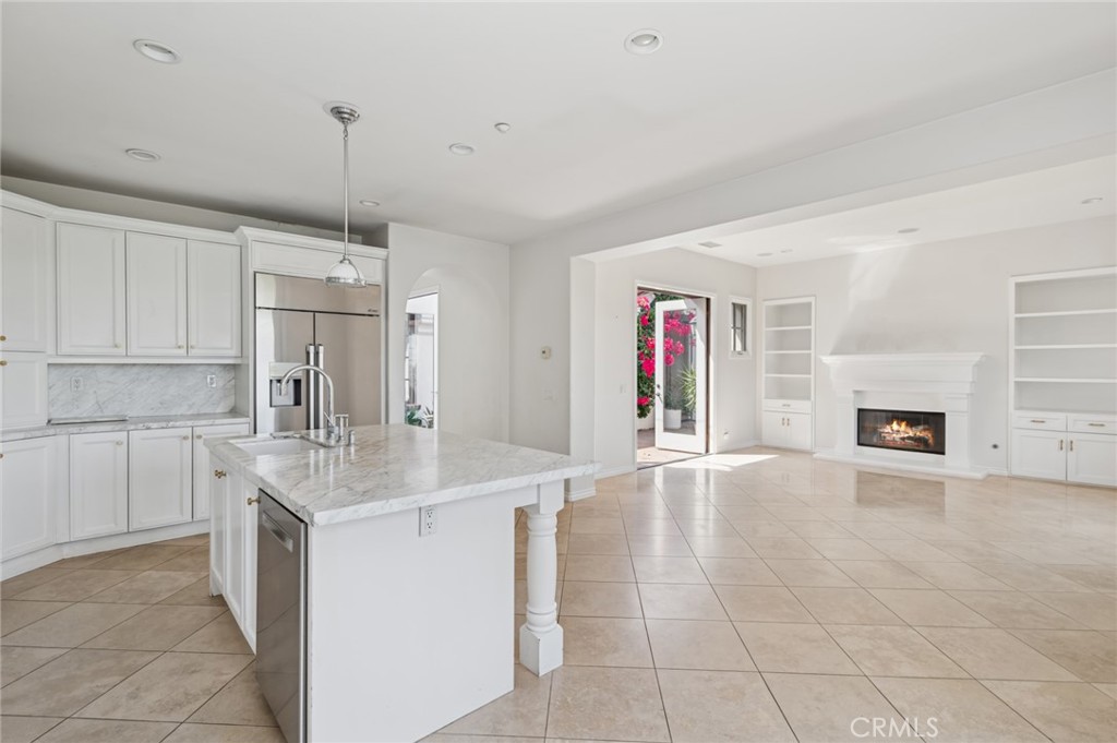 4 Still Water Newport Coast, CA 92657 - Photo 10 of 43 a kitchen with granite countertop a sink and white cabinets
