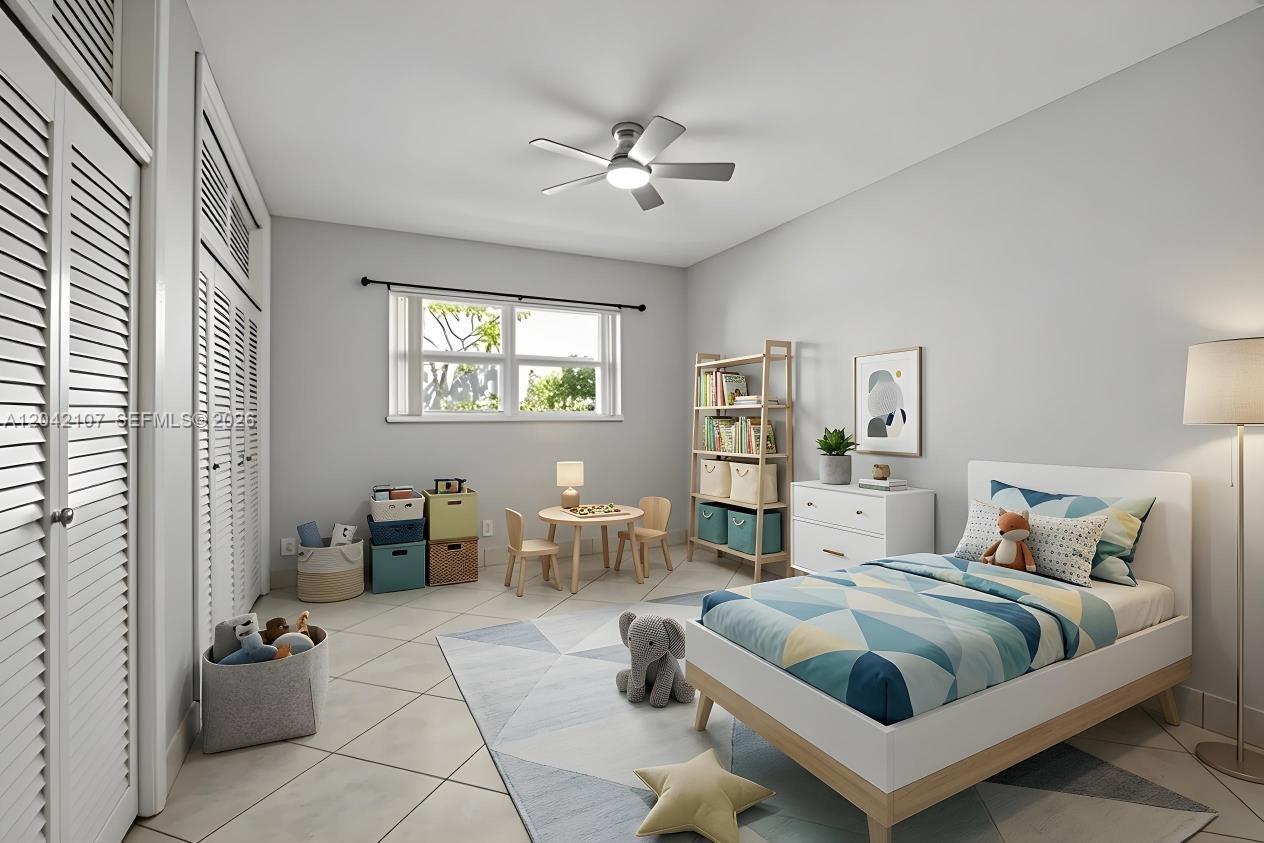 3213 Colony Club Road, Unit 3E Pompano Beach, FL 33062 - Photo 26 of 31 a bedroom with a large bed and a chandelier