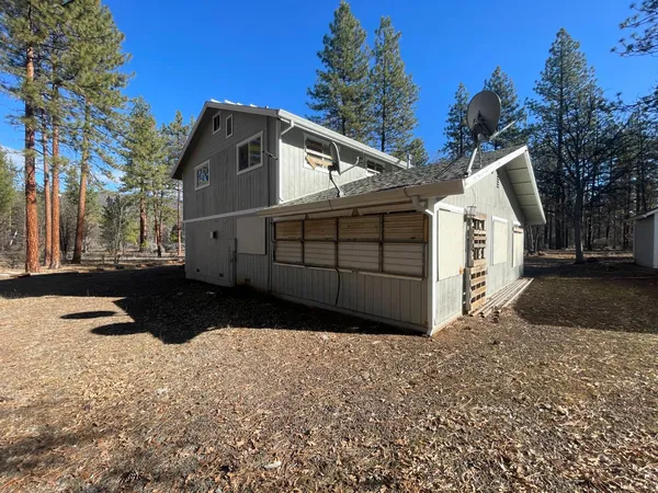a view of a white house with a yard