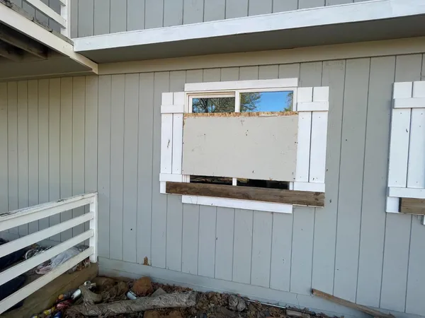 a room with a wooden door and white walls