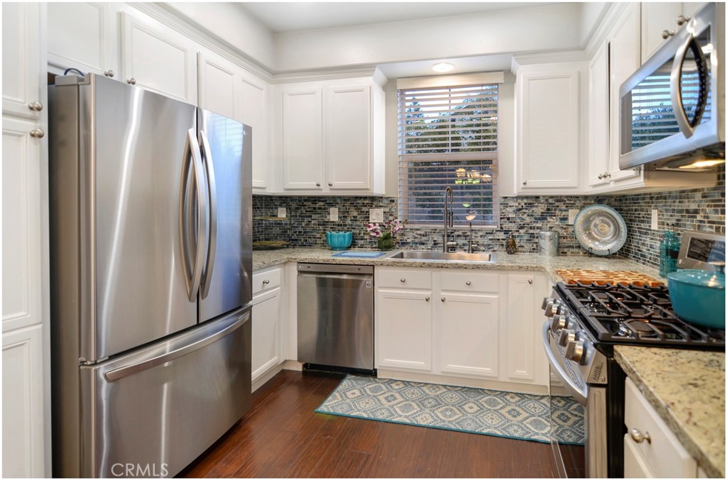 2 Hinterland Way Ladera Ranch, CA 92694 - Photo 4 of 29 a kitchen with stainless steel appliances granite countertop a refrigerator sink and stove