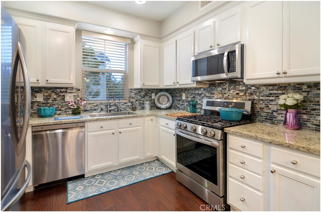 2 Hinterland Way Ladera Ranch, CA 92694 - Photo 5 of 29 a kitchen with stainless steel appliances granite countertop a stove a sink and a microwave