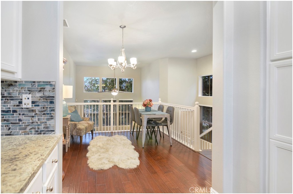 2 Hinterland Way Ladera Ranch, CA 92694 - Photo 7 of 29 a view of a dining room with furniture a chandelier and wooden floor