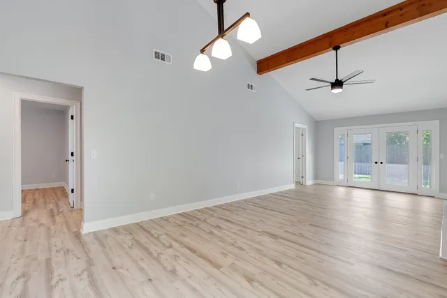 wooden floor in an empty room with a window