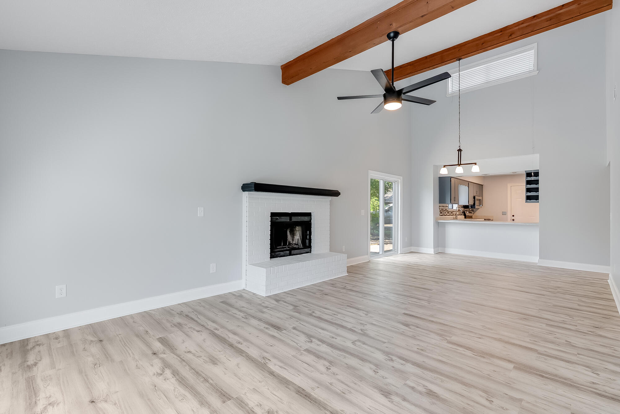 1307 Calabria Road, Unit 4A Panama City, FL 32405 - Photo 16 of 35 a view of empty room with wooden floor and fireplace
