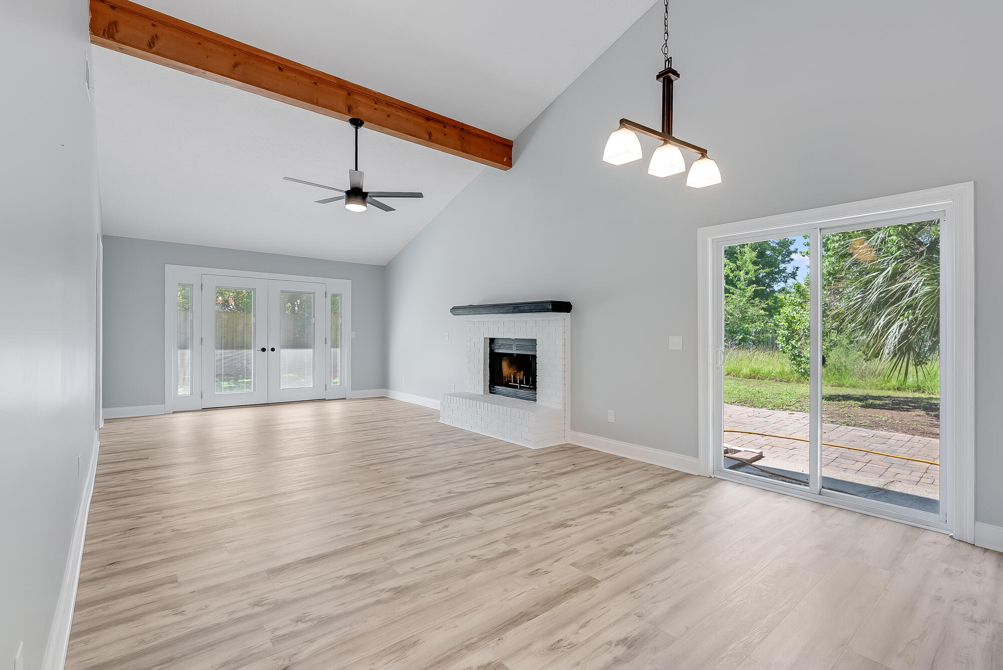 1307 Calabria Road, Unit 4A Panama City, FL 32405 - Photo 17 of 35 a view of an empty room with wooden floor and a window
