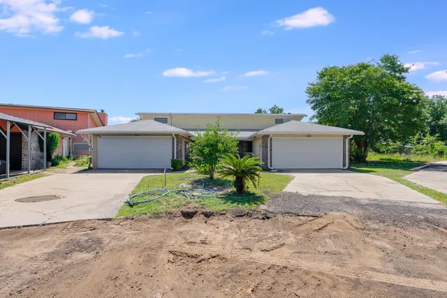 a front view of a house with a yard and a garage