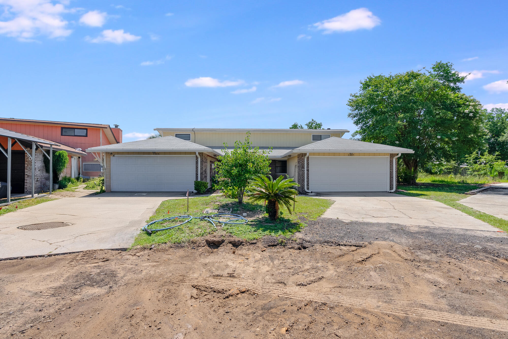 1307 Calabria Road, Unit 4A Panama City, FL 32405 - Photo 2 of 35 a front view of a house with a yard and a garage