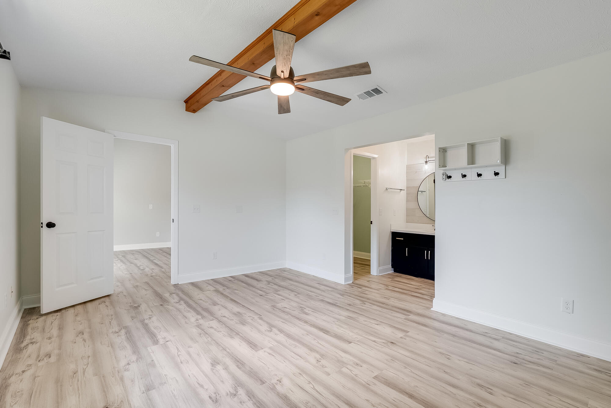1307 Calabria Road, Unit 4A Panama City, FL 32405 - Photo 22 of 35 a view of empty room with wooden floor and ceiling fan