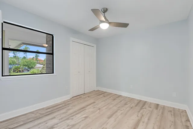 wooden floor in an empty room with a window