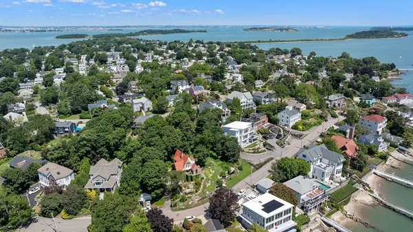 an aerial view of residential houses with outdoor space and river