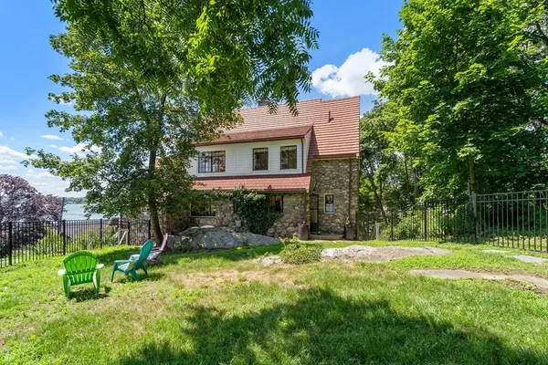 a view of backyard of house with green space