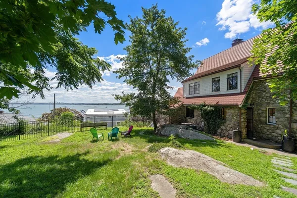 a view of backyard of house with green space