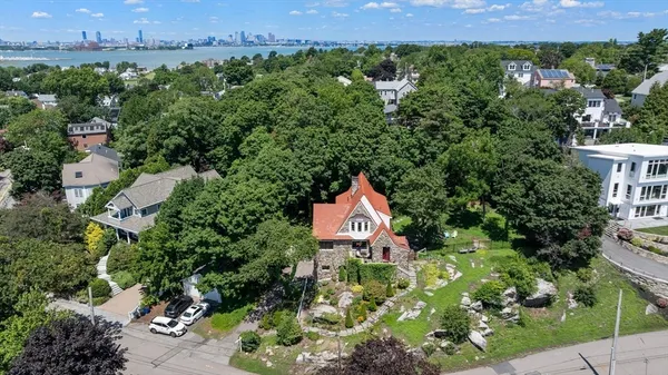 an aerial view of a house with a yard and lake view