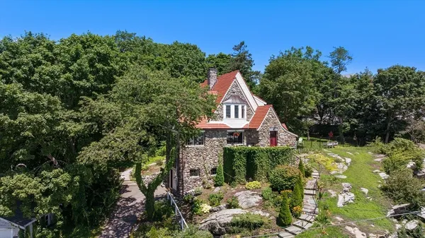 a view of a house with a yard and garden