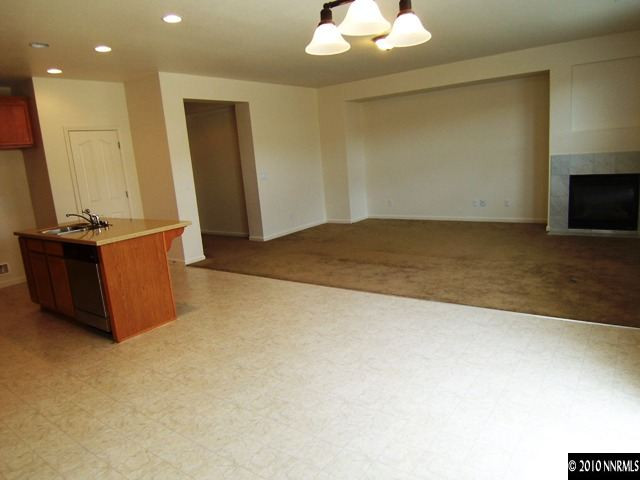 11410 Cervino Drive Reno, NV 89521 - Photo 3 of 13 an empty room with a fireplace