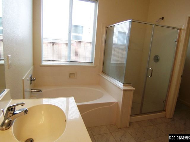11410 Cervino Drive Reno, NV 89521 - Photo 8 of 13 a bathroom with a tub and shower