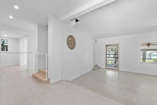 an empty room with windows and entrance