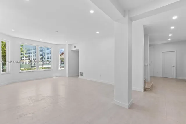 an empty room with windows and entrance