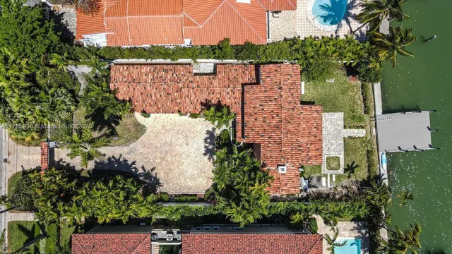 an aerial view of a house with a yard and garden