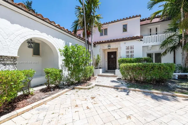 a view of a house with potted plants