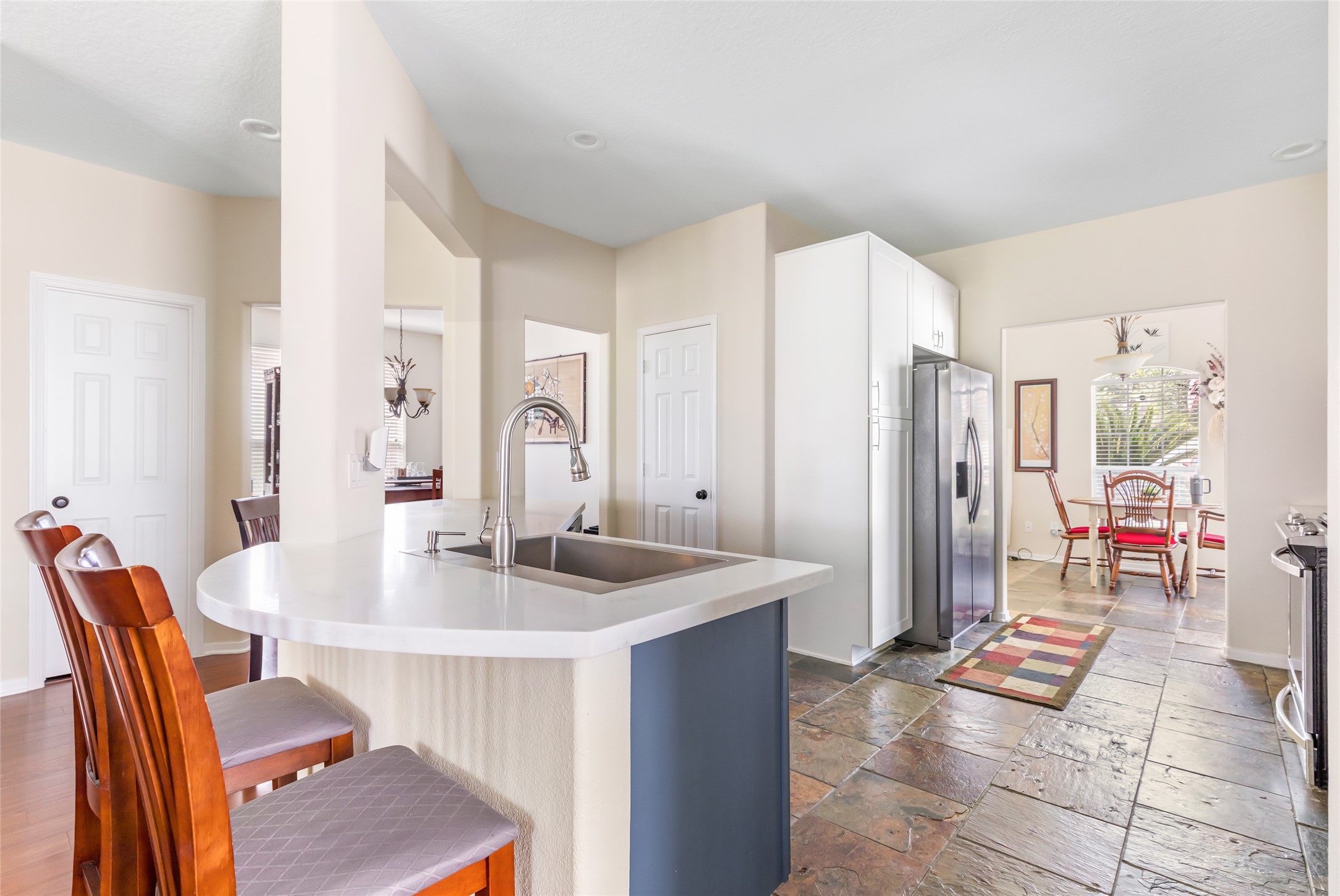 12122 Landsdown Ridge Way Humble, TX 77346 - Photo 11 of 34 a kitchen with stainless steel appliances granite countertop a table chairs and a refrigerator