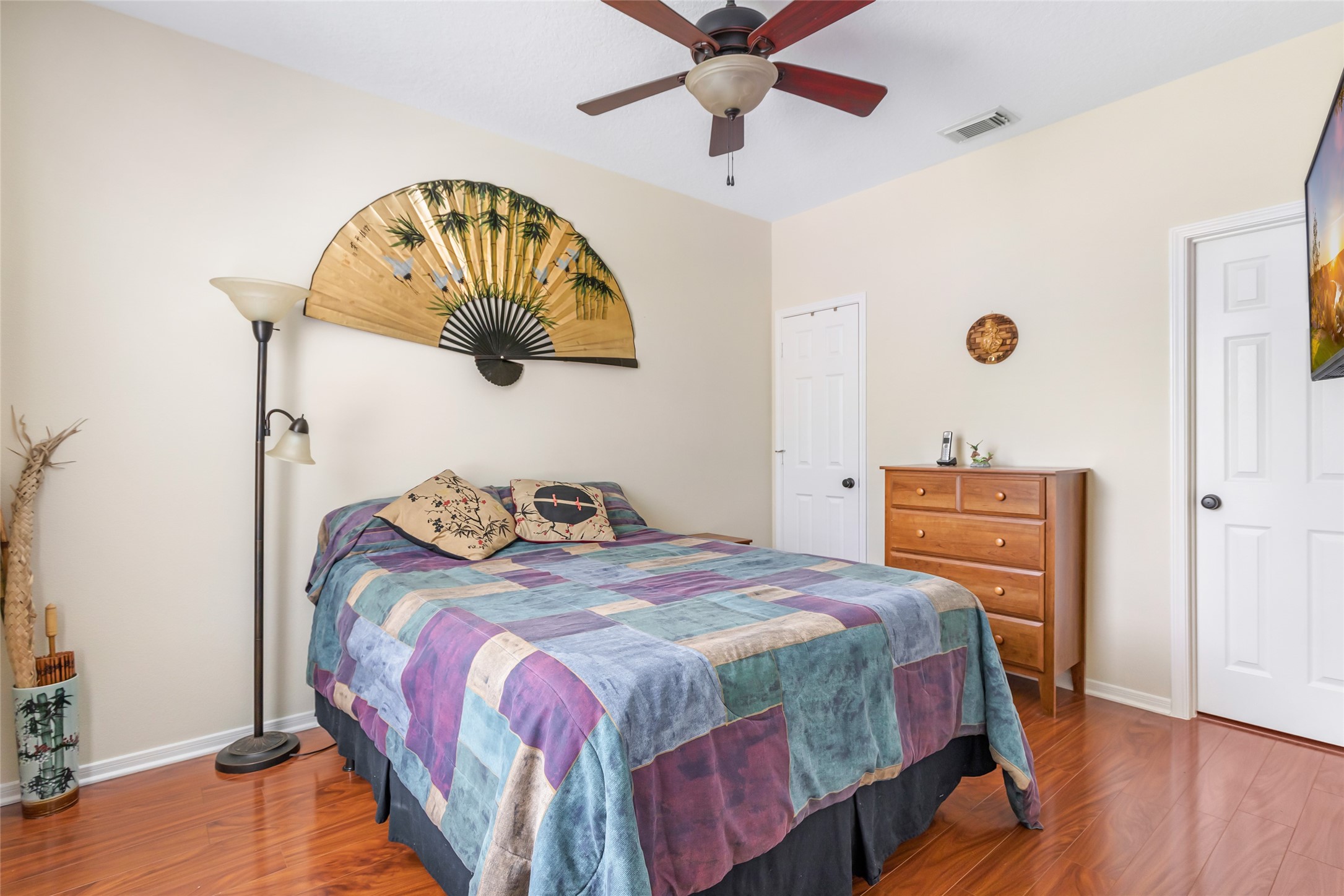 12122 Landsdown Ridge Way Humble, TX 77346 - Photo 20 of 34 a bedroom with a bed and a chandelier
