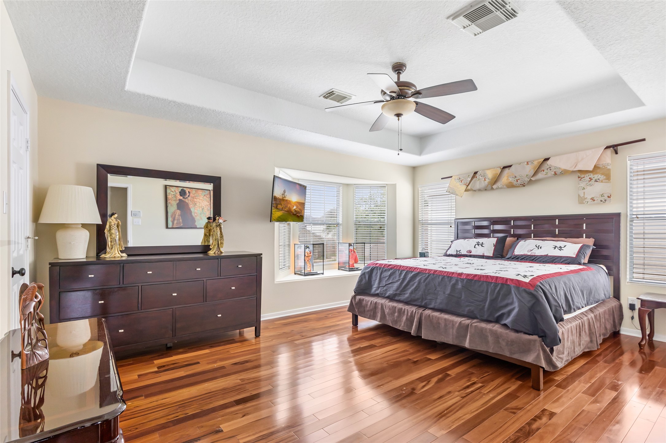 12122 Landsdown Ridge Way Humble, TX 77346 - Photo 21 of 34 a spacious bedroom with a large bed and a dresser