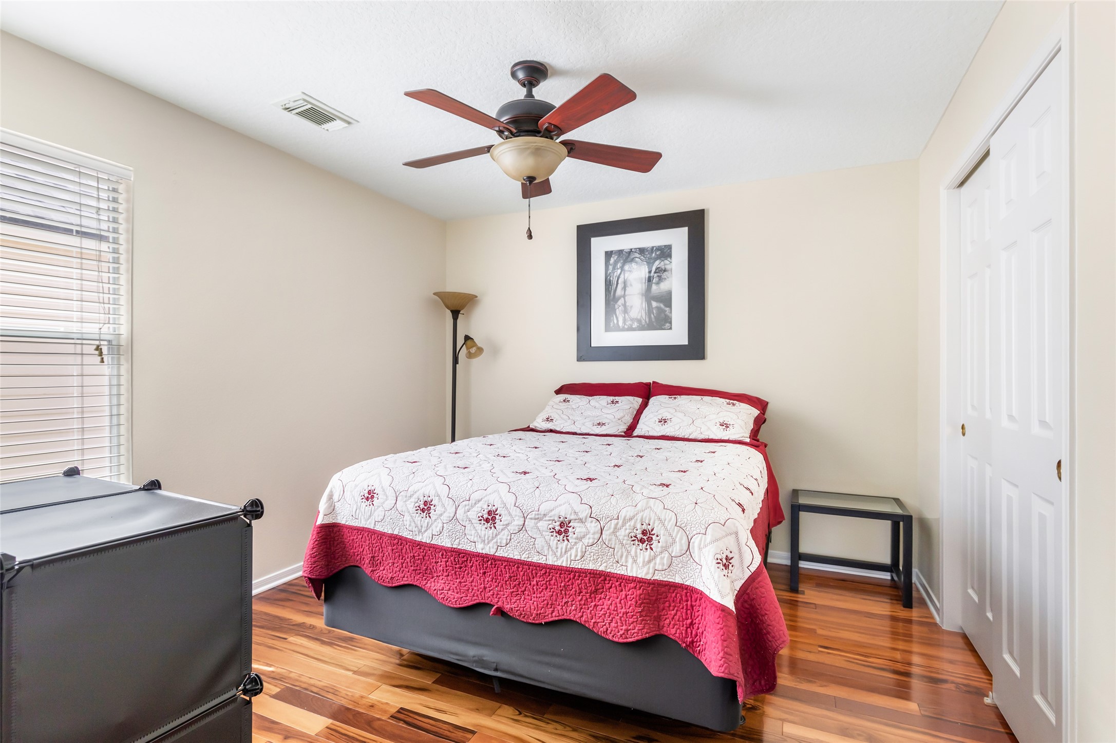 12122 Landsdown Ridge Way Humble, TX 77346 - Photo 23 of 34 a bedroom with a bed and a chandelier