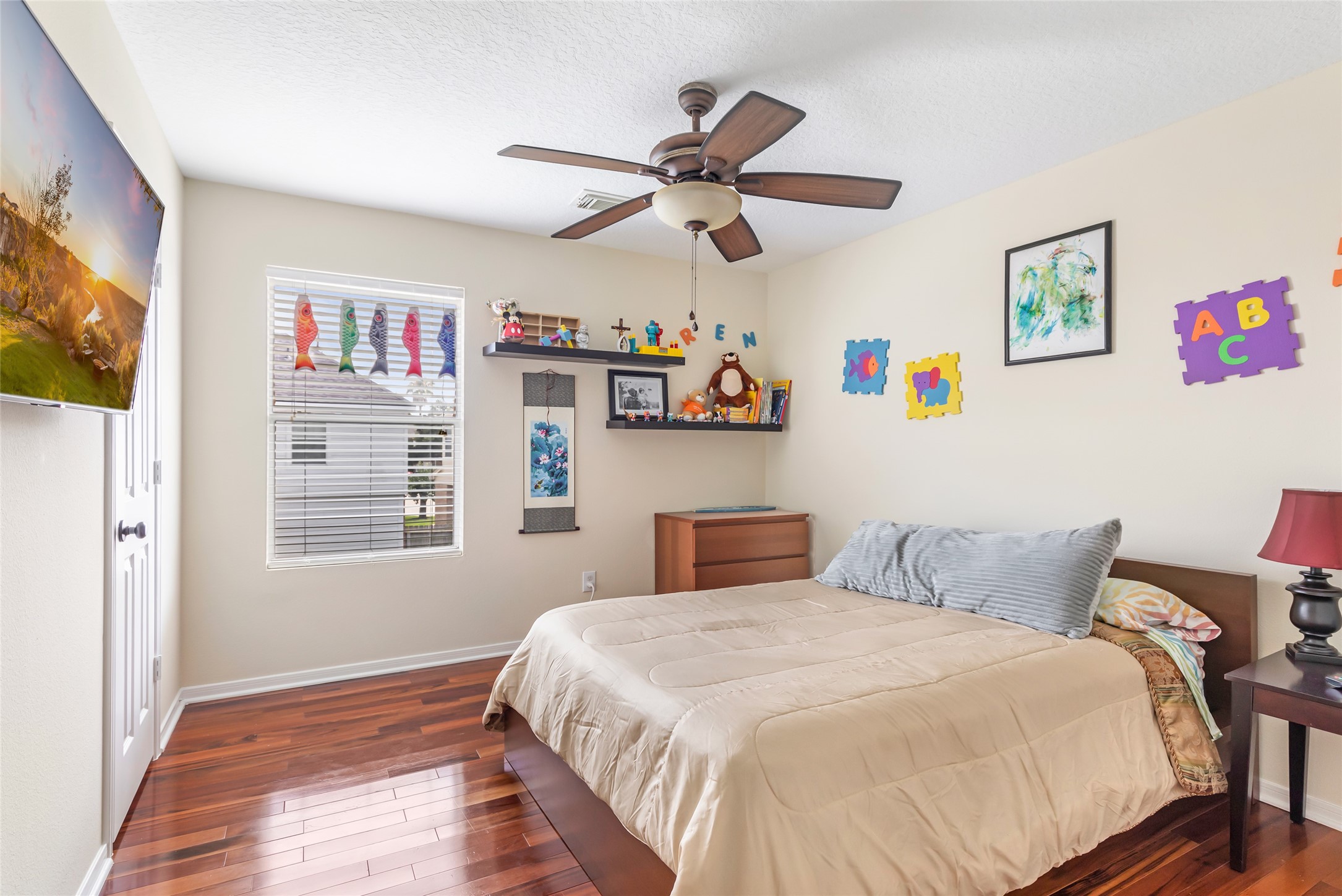12122 Landsdown Ridge Way Humble, TX 77346 - Photo 26 of 34 a bedroom with a bed and wooden floor