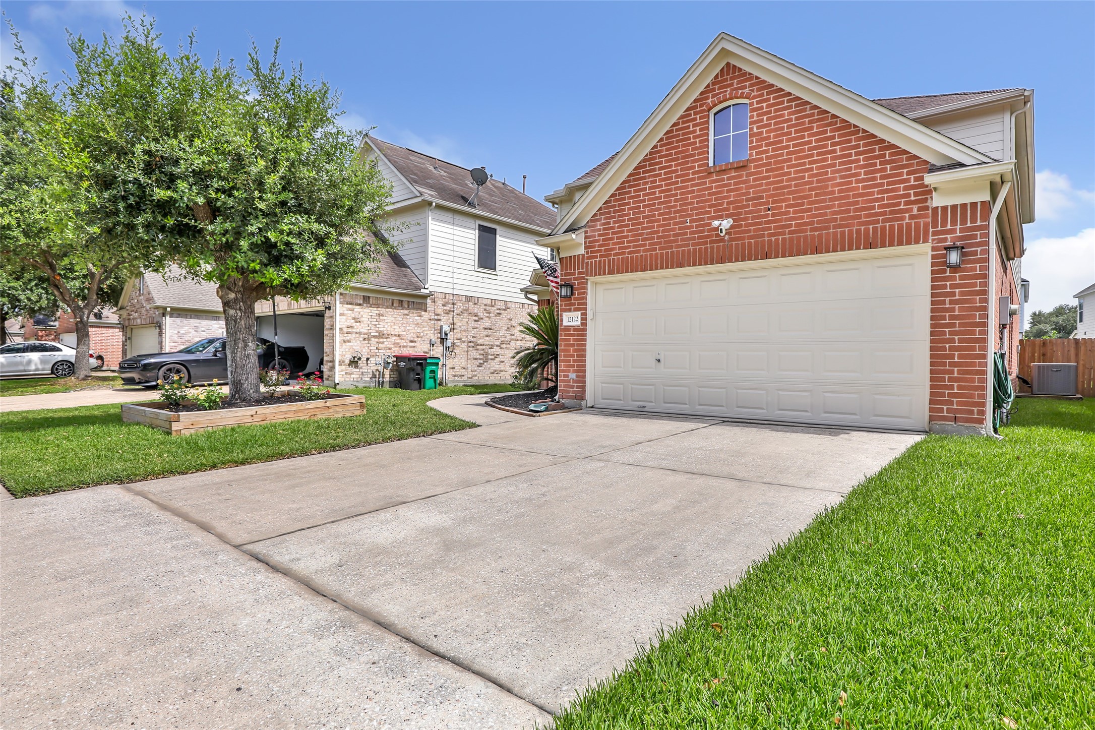 12122 Landsdown Ridge Way Humble, TX 77346 - Photo 3 of 34 a front view of a house with a yard and garage