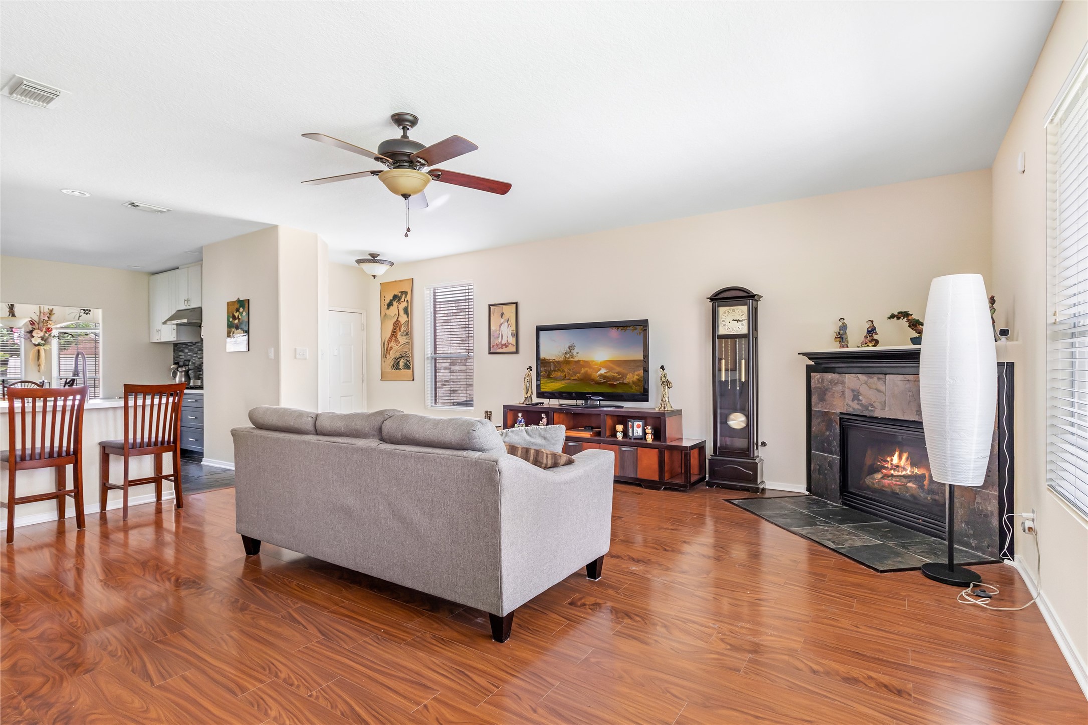 12122 Landsdown Ridge Way Humble, TX 77346 - Photo 9 of 34 a living room with furniture a flat screen tv and a fireplace