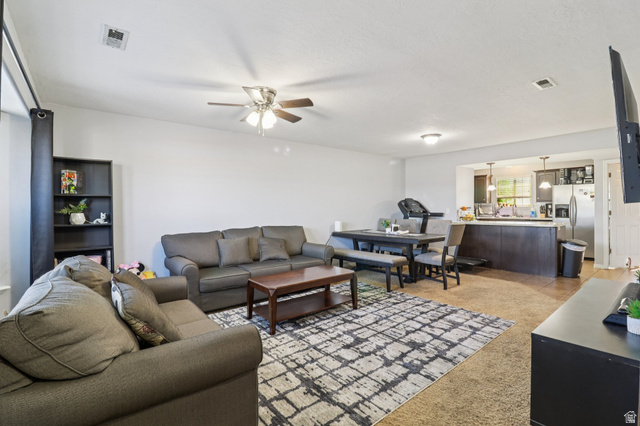 1077 South 1850th Street West Springville, UT 84663 - Photo 4 of 22 Living room featuring ceiling fan and light carpet