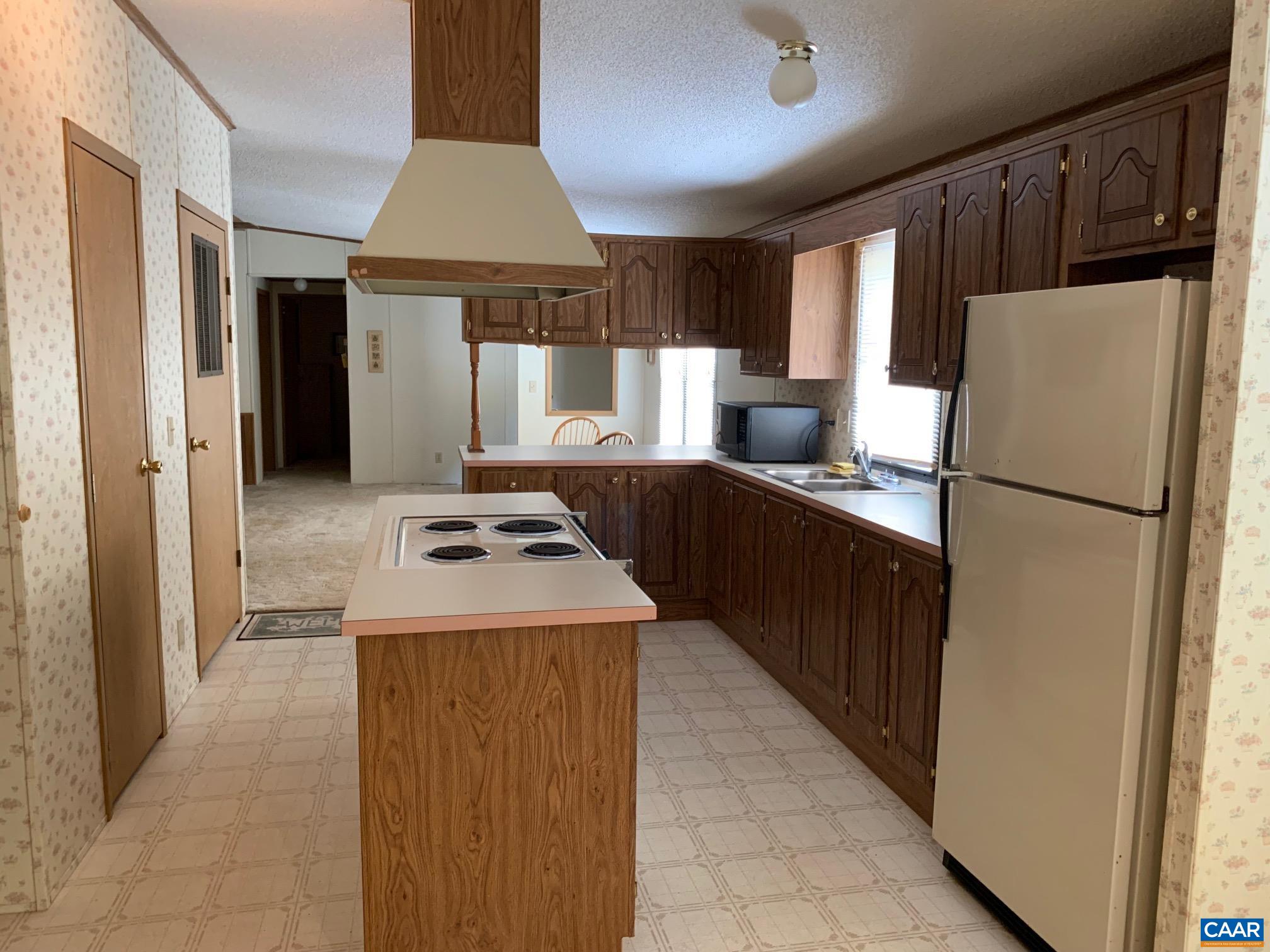 3981 South Blue Ridge Turnpike Rochelle, VA 22738 - Photo 11 of 15 a kitchen with stainless steel appliances granite countertop a refrigerator a sink and a stove