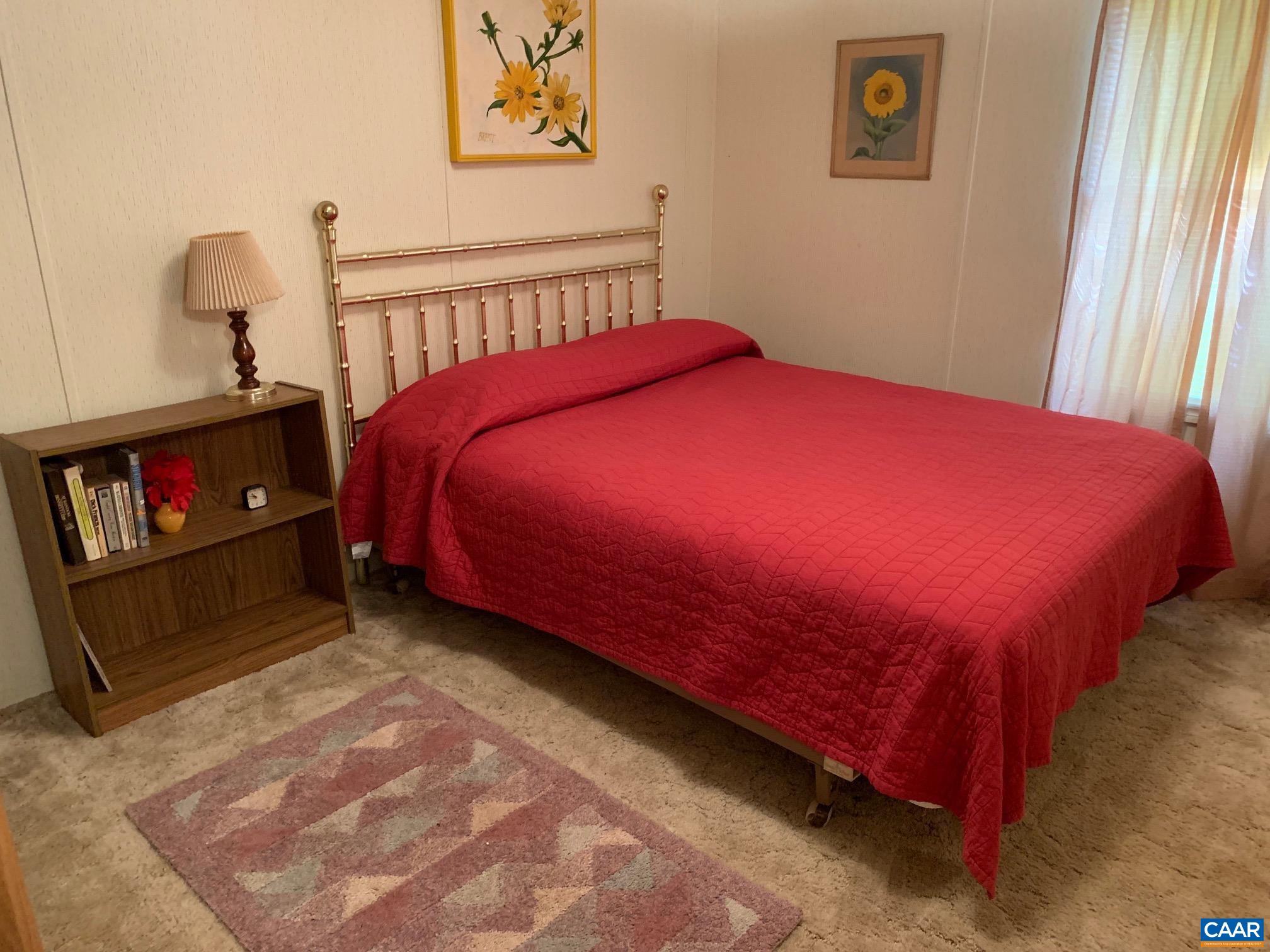 3981 South Blue Ridge Turnpike Rochelle, VA 22738 - Photo 13 of 15 a large bed sitting in a bedroom next to a window