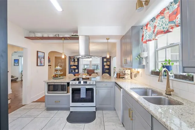 a kitchen with stainless steel appliances granite countertop a sink and cabinets