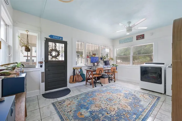 a living room with furniture a window and a table