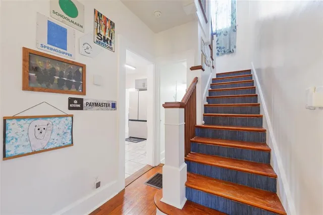 a view of entryway with stairs and wooden floor