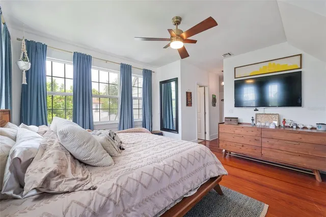 a bedroom with a bed and a flat screen tv
