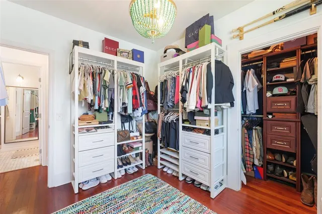 a view of walk in closet with clothes and shoes