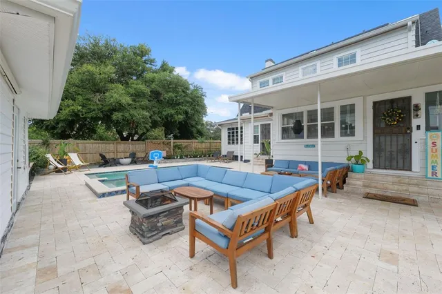 a view of a patio with table and chairs and potted plants