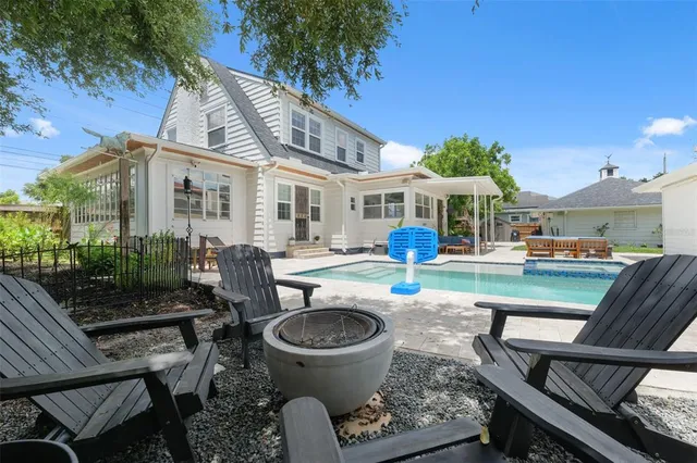 a view of a patio with table and chairs potted plants and palm tree