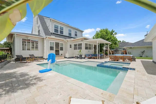 a view of a patio with swimming pool table and chairs