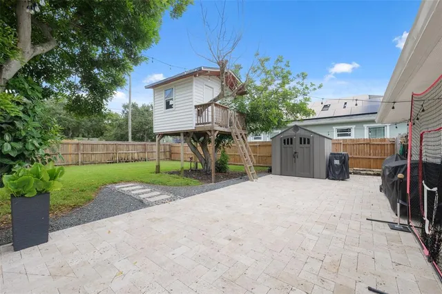 a view of a house with a backyard and a garage