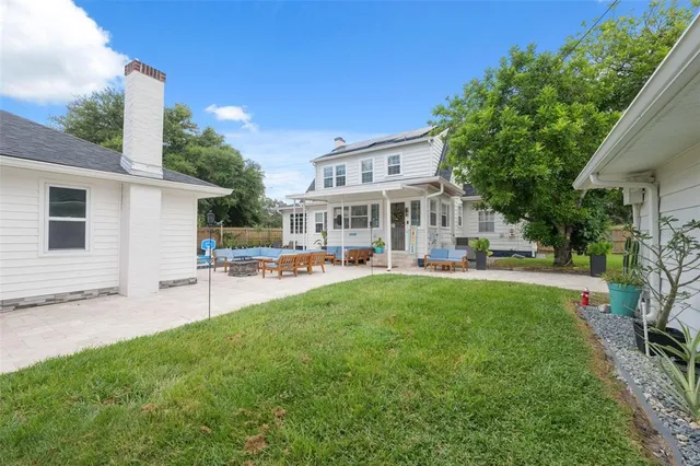a view of a house with sitting area and a yard