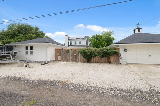 a backyard of a house with plants and trees