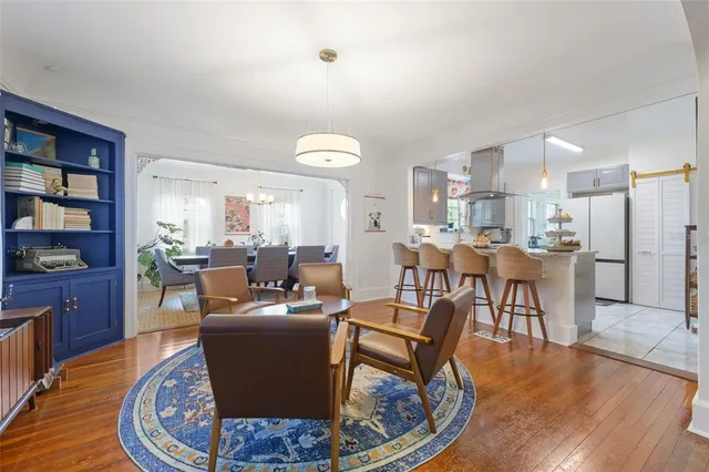 a living room with fireplace furniture and a wooden floor